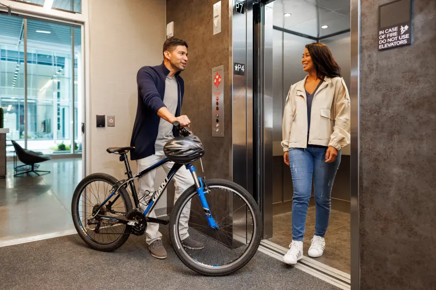 A decorative image of tenants at an elevator in a residential setting.